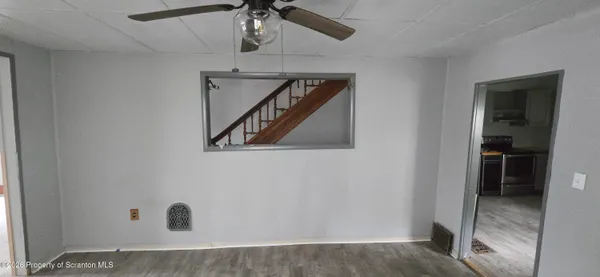 a view of an empty room with closet and a window
