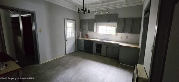 a bathroom with a shower and a sink