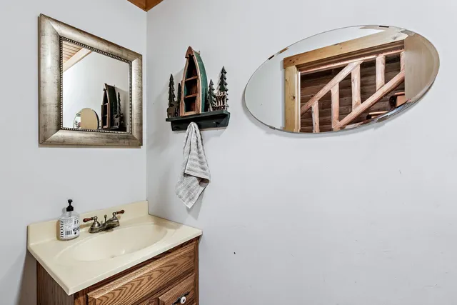 a bathroom with a sink and a mirror
