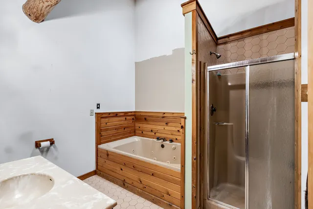 a bathroom with a tub and shower