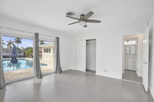 a view of a livingroom with a ceiling fan and window