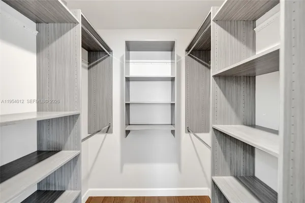 a view of walk in closet with empty racks