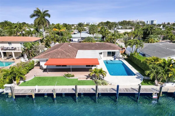an aerial view of a house with a yard