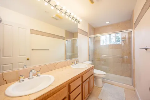a bathroom with a sink a toilet and shower