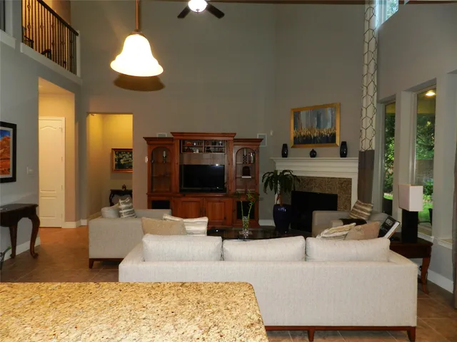 a living room with furniture a fireplace and a flat screen tv