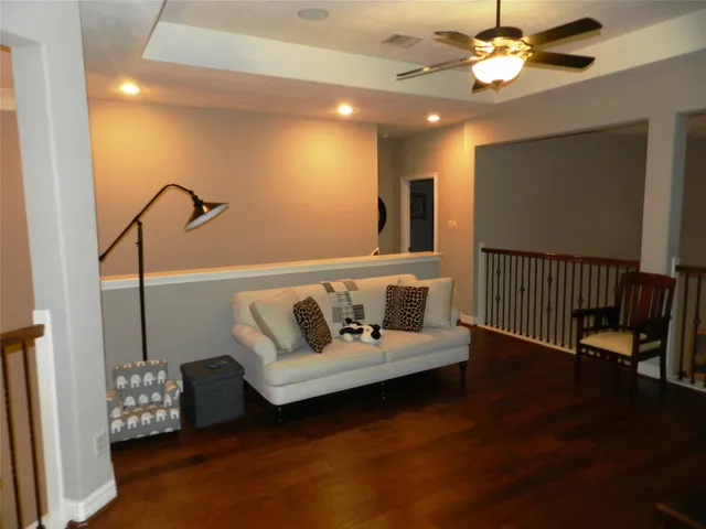 a living room with furniture and wooden floor