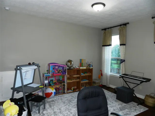 a bedroom with furniture and a window