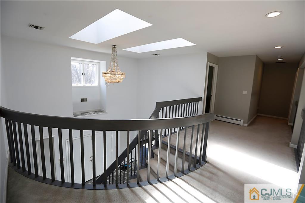 268 Friendship Road Monmouth Junction, NJ 08852 - Photo 11 of 24 a view of staircase with wooden floor and windows
