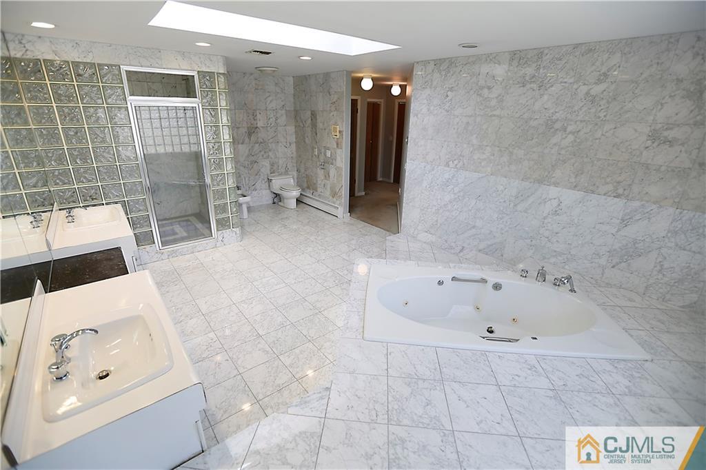 268 Friendship Road Monmouth Junction, NJ 08852 - Photo 15 of 24 a bathroom with a tub a rug and shower