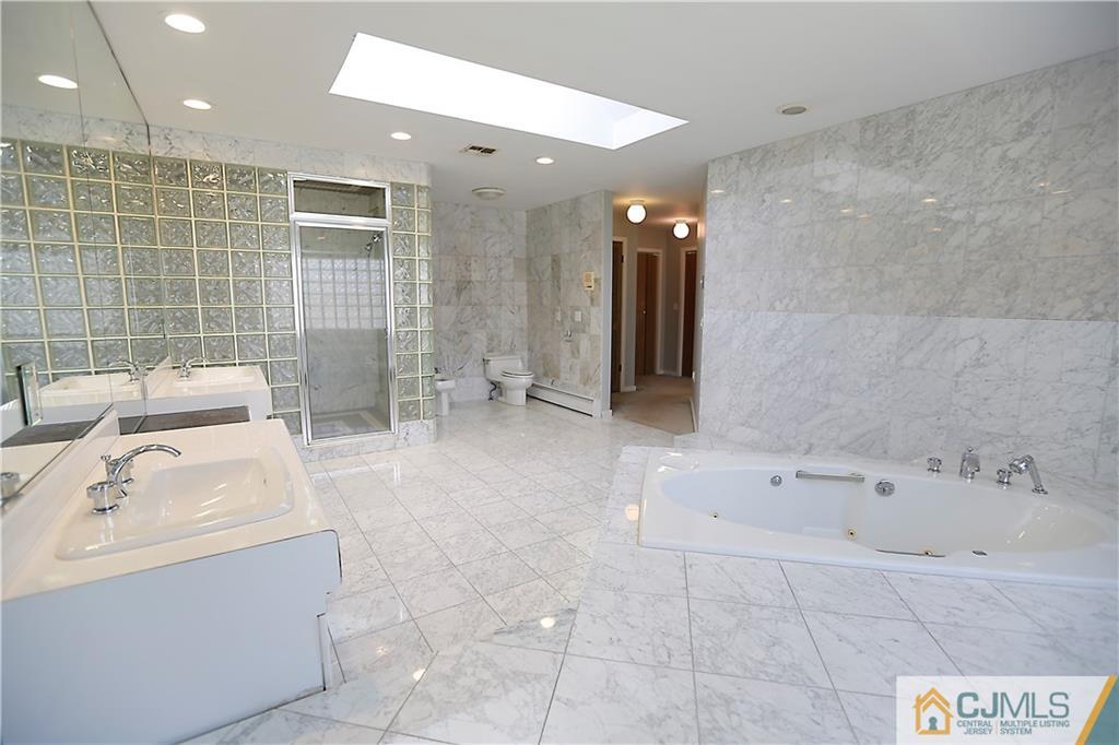 268 Friendship Road Monmouth Junction, NJ 08852 - Photo 16 of 24 a bathroom with a bathtub and a sink
