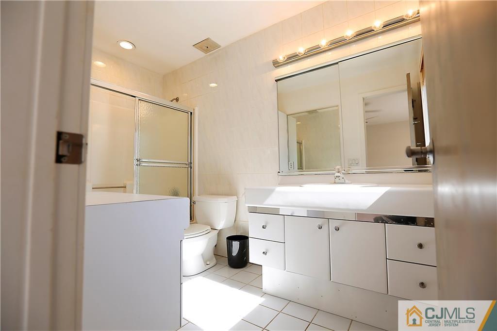 268 Friendship Road Monmouth Junction, NJ 08852 - Photo 17 of 24 a bathroom with a sink a toilet and a mirror
