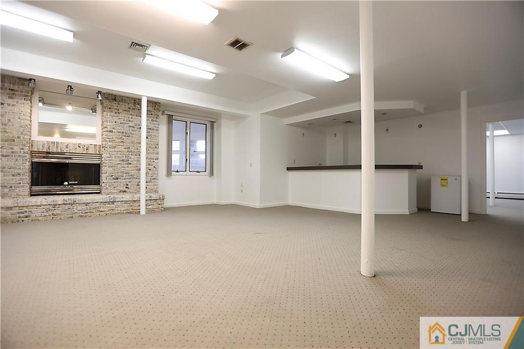 268 Friendship Road Monmouth Junction, NJ 08852 - Photo 18 of 24 an empty room with fireplace and windows