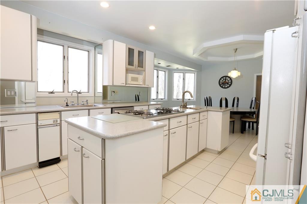 268 Friendship Road Monmouth Junction, NJ 08852 - Photo 9 of 24 a kitchen with a sink window and cabinets