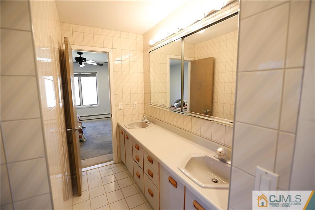 268 Friendship Road Monmouth Junction, NJ 08852 - Photo 10 of 24 a bathroom with a double vanity sink and mirror