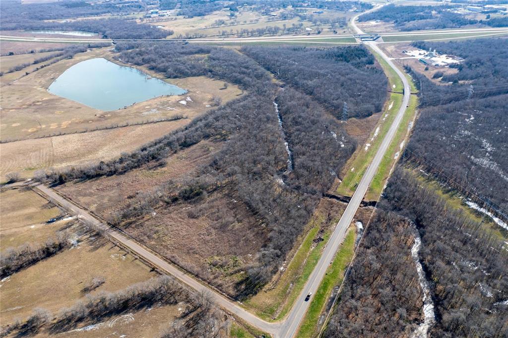 0 State Highway Commerce, TX 75428 - Photo 2 of 4 a view of a backyard with wooden fence
