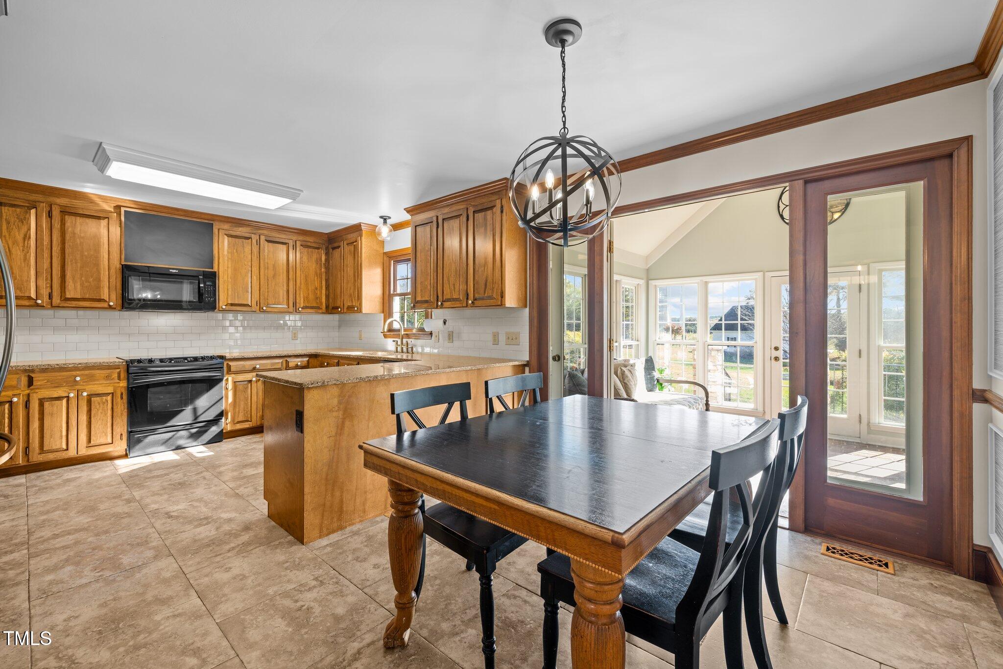 7205 Penny Road Raleigh, NC 27606 - Photo 14 of 50 a view of a dining room with furniture window and wooden floor