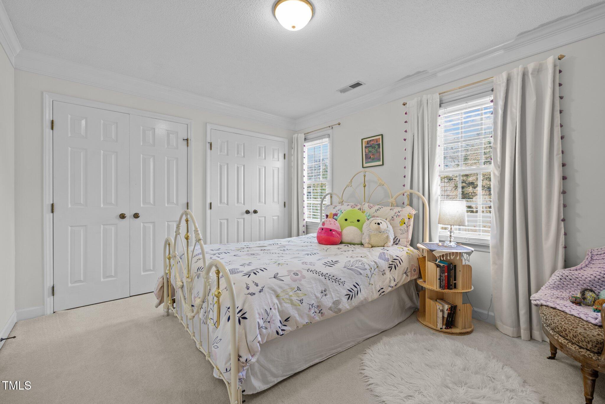 7205 Penny Road Raleigh, NC 27606 - Photo 20 of 50 a bedroom with a bed and a window