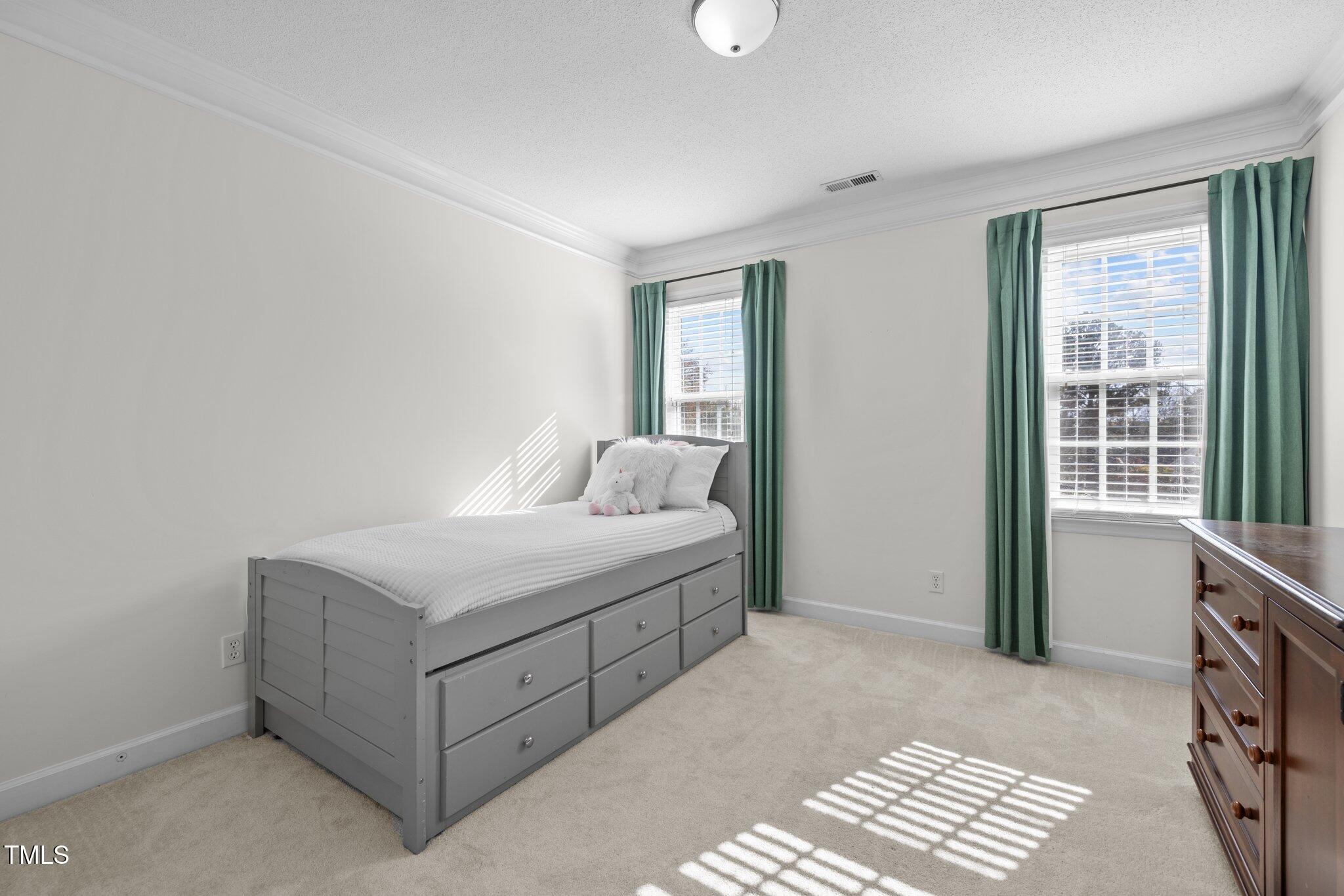 7205 Penny Road Raleigh, NC 27606 - Photo 21 of 50 a room with a bed and a window