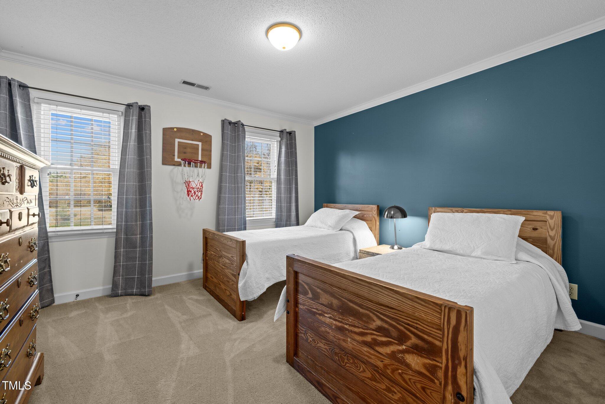 7205 Penny Road Raleigh, NC 27606 - Photo 22 of 50 a large bedroom with bed and a window