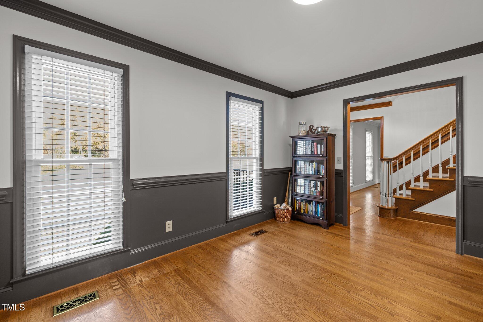 7205 Penny Road Raleigh, NC 27606 - Photo 8 of 50 a view of an empty room with window and wooden floor