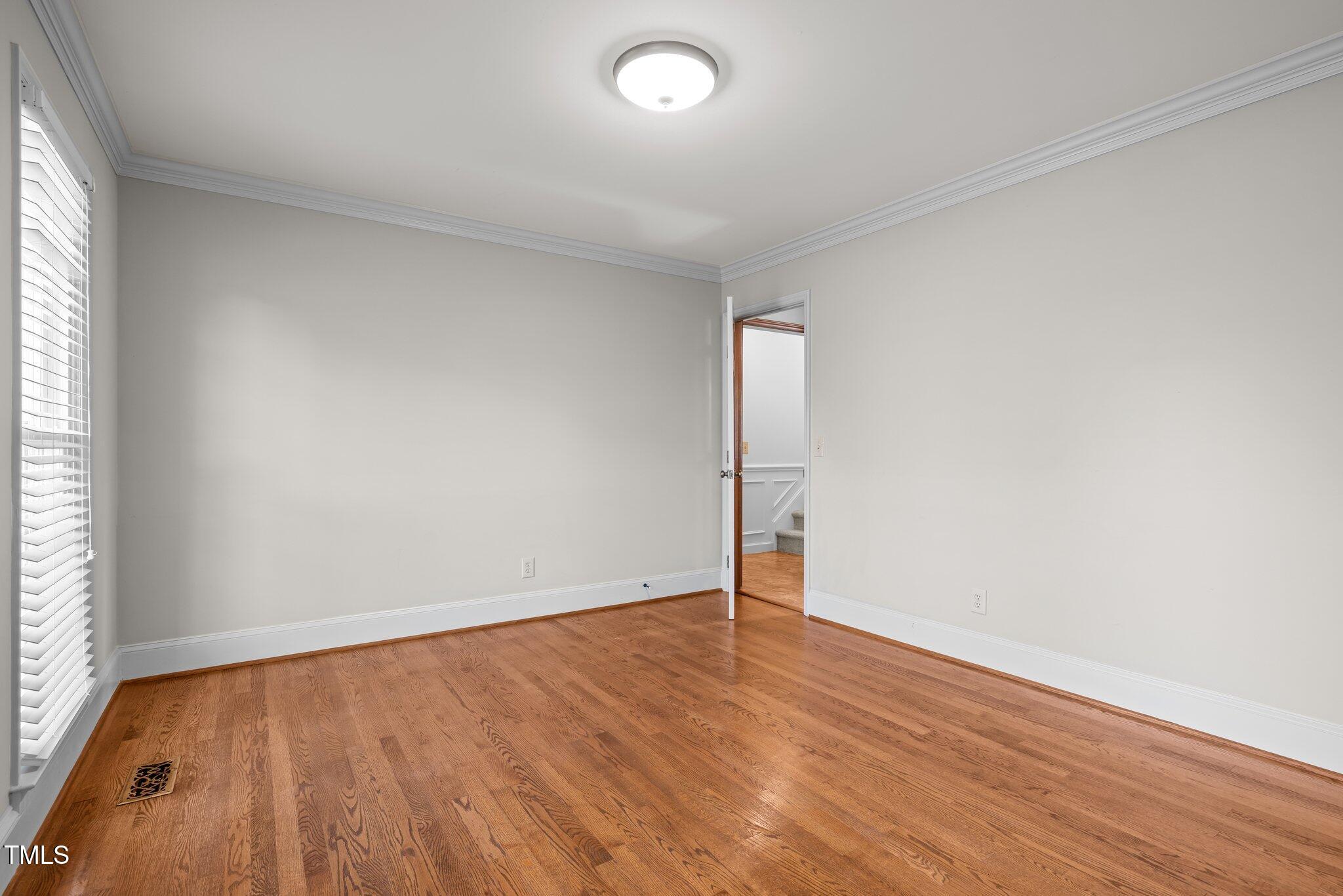 7205 Penny Road Raleigh, NC 27606 - Photo 9 of 50 an empty room with wooden floor and windows