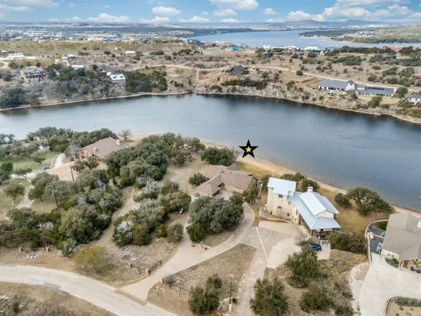 an aerial view of a house with a lake view