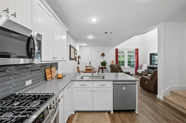 a kitchen that has a lot of cabinets in it