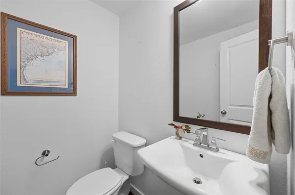 a bathroom with a sink mirror and toilet