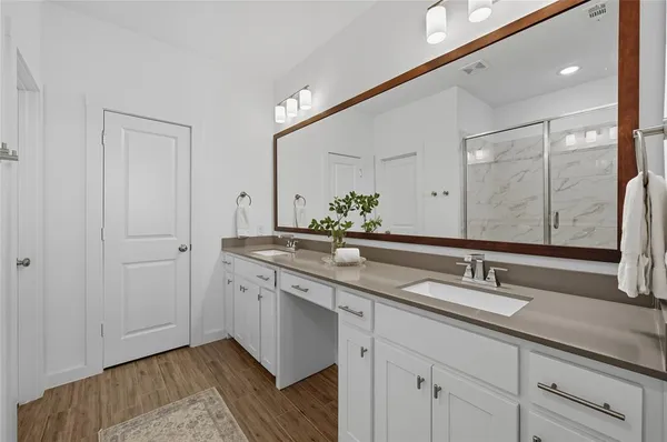 a bathroom with 2 sink and a mirror