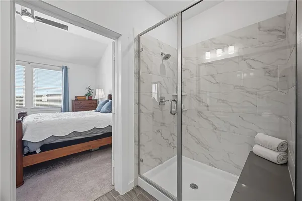 a bed room with a bed and a shower