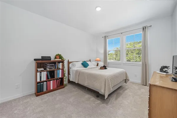 a room with a bed and a book shelf