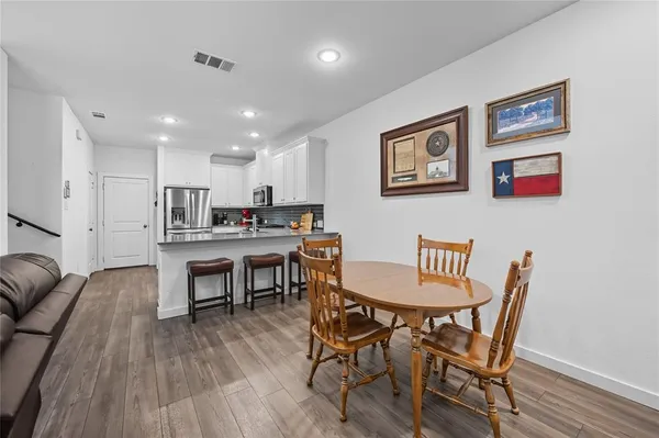 a view of a dining room with furniture and wooden floor