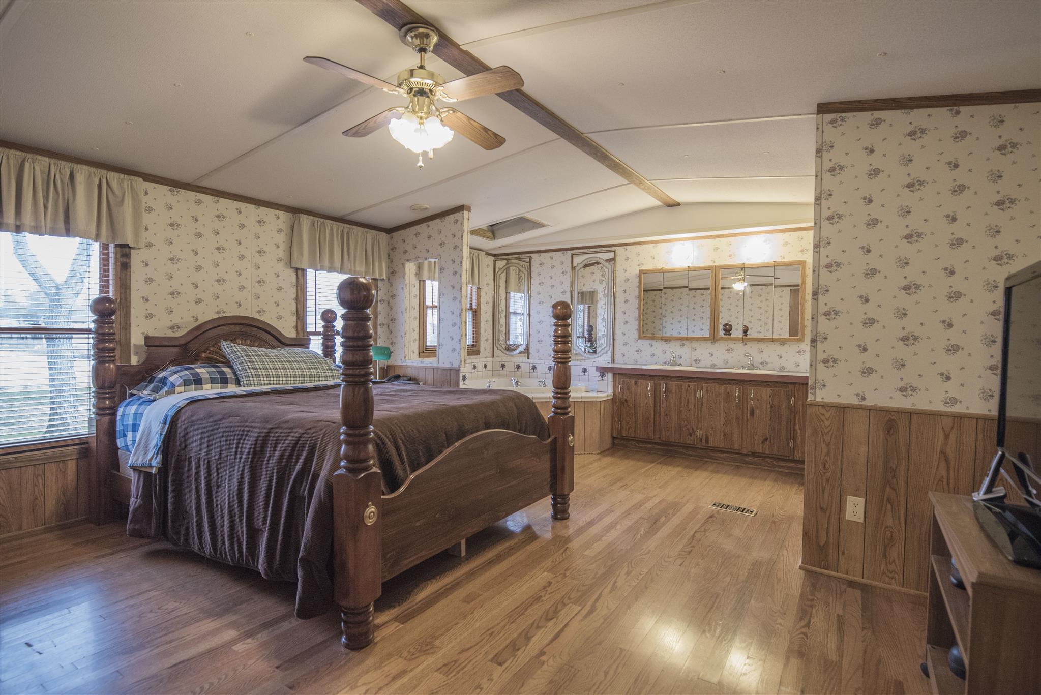 123 Norris Perry Road Manchester, TN 37355 - Photo 11 of 23 a spacious bedroom with a bed and a chandelier