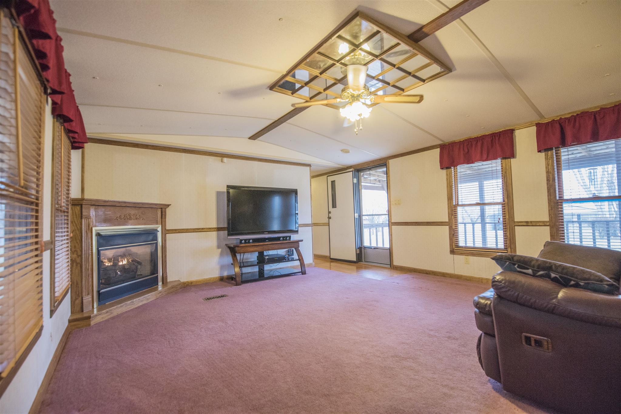 123 Norris Perry Road Manchester, TN 37355 - Photo 9 of 23 a living room with furniture a flat screen tv and a floor to ceiling window