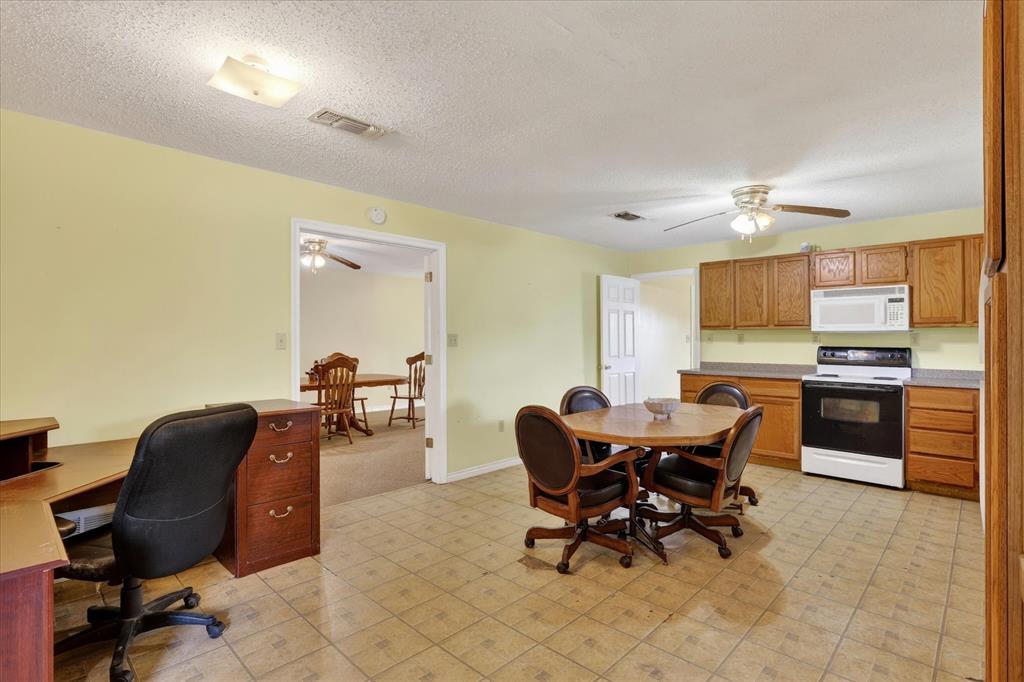 1092 West Highway 199 Springtown, TX 76082 - Photo 10 of 29 Kitchen with range, microwave and ceiling fan