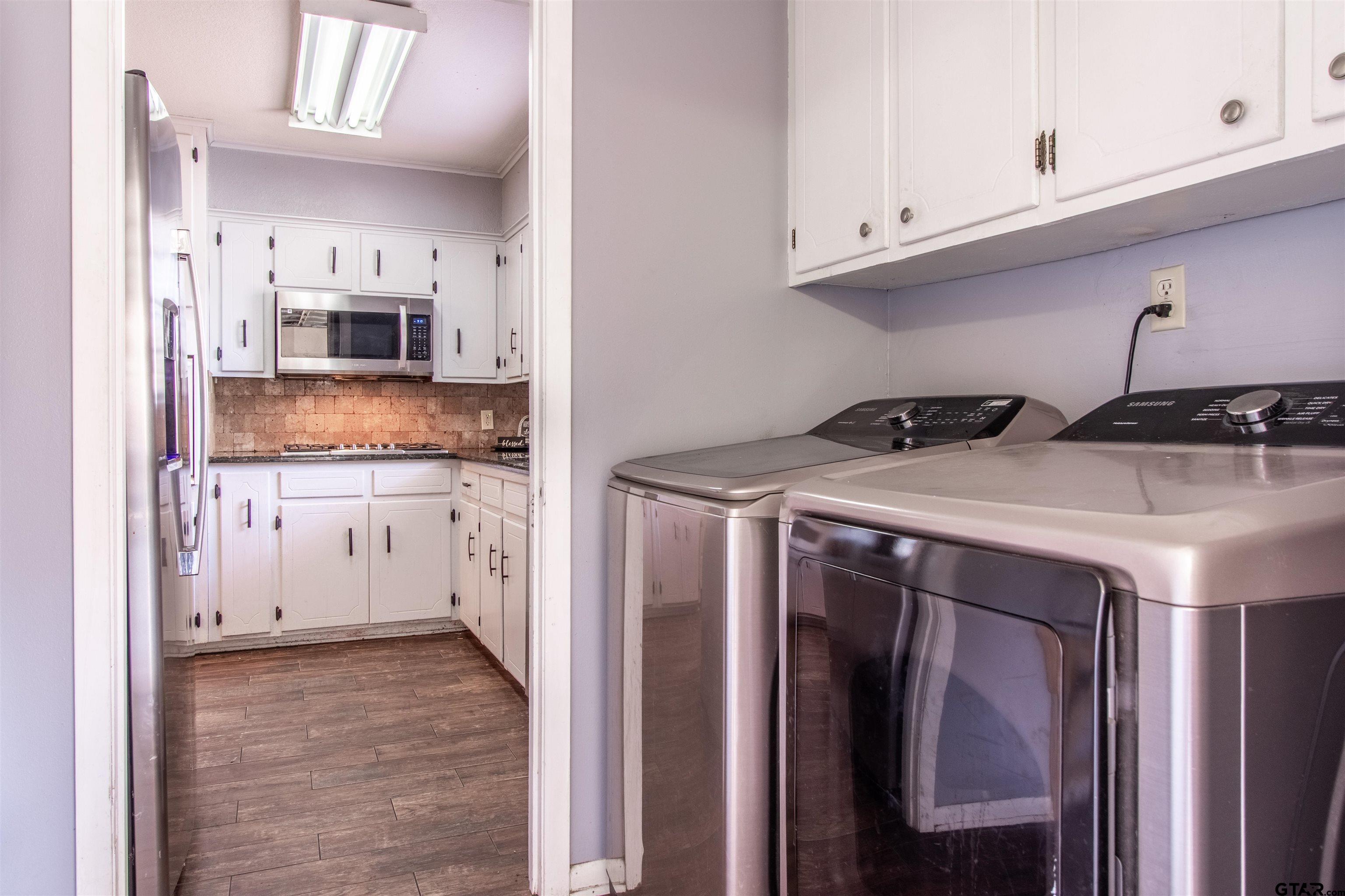 727 Oxford Drive Tyler, TX 75703 - Photo 12 of 33 a kitchen with stainless steel appliances granite countertop a refrigerator a stove and white cabinets