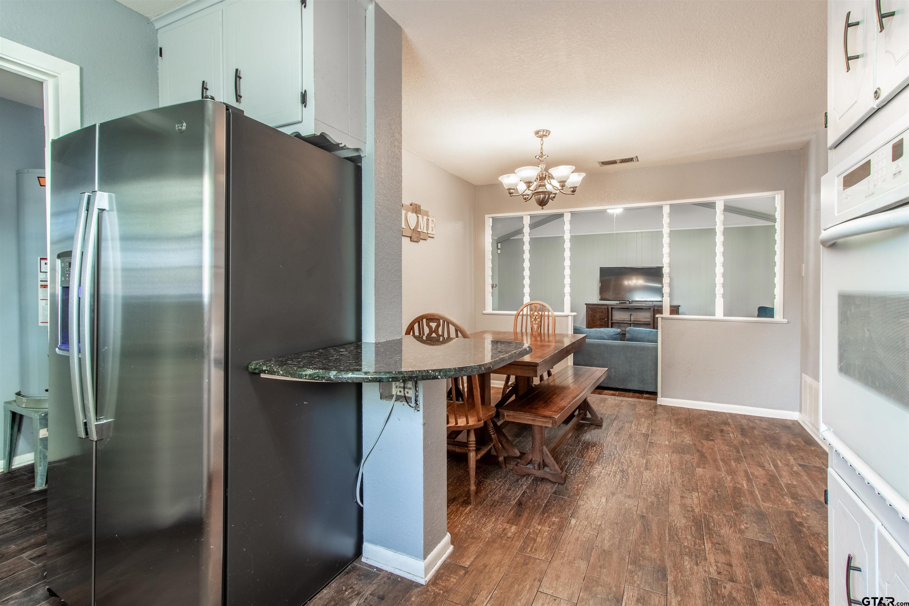 727 Oxford Drive Tyler, TX 75703 - Photo 13 of 33 a kitchen with stainless steel appliances a refrigerator and a wooden cabinets