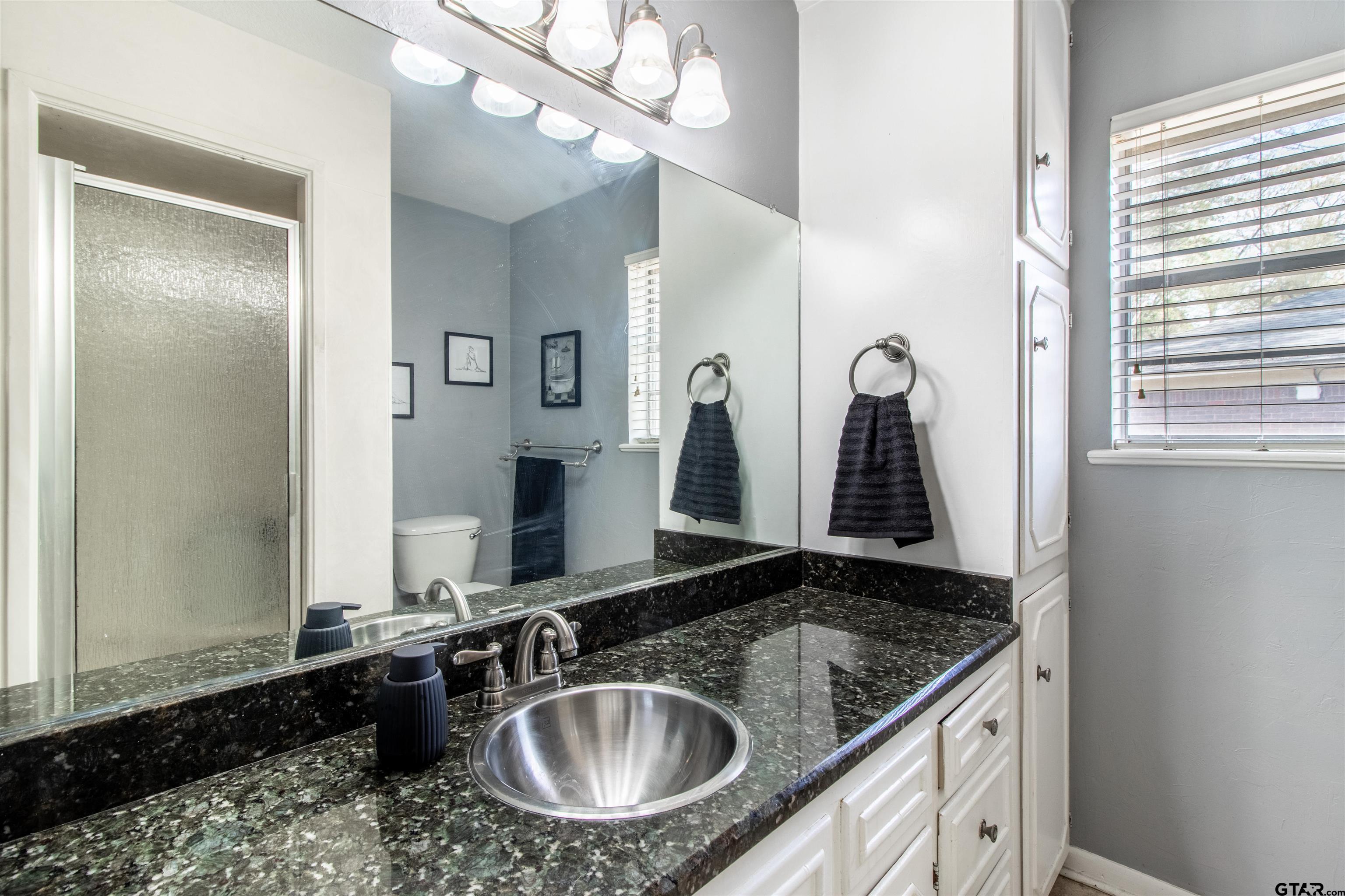 727 Oxford Drive Tyler, TX 75703 - Photo 16 of 33 a bathroom with a granite countertop sink and a mirror