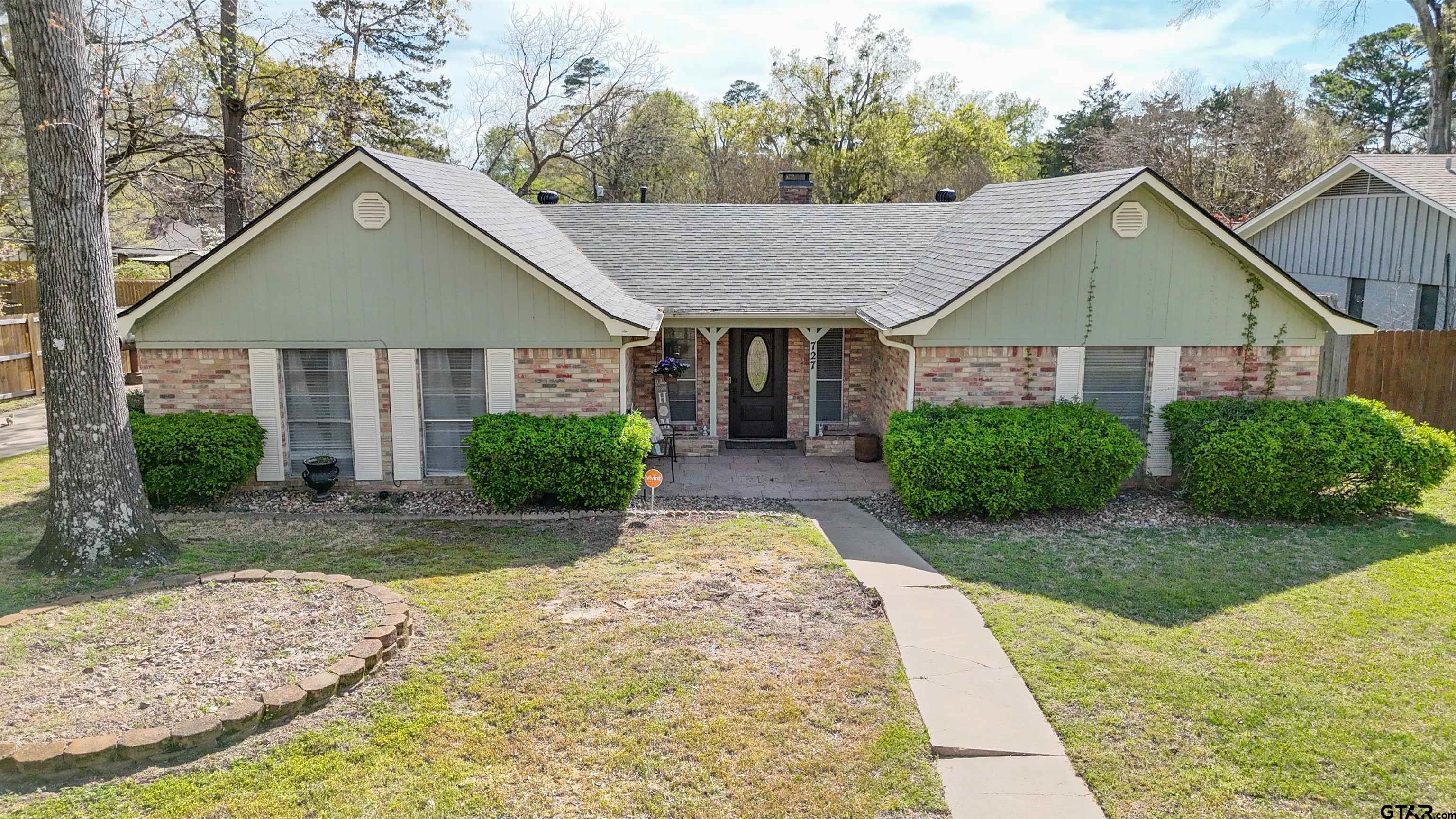 727 Oxford Drive Tyler, TX 75703 - Photo 2 of 33 a front view of a house with a yard and garage