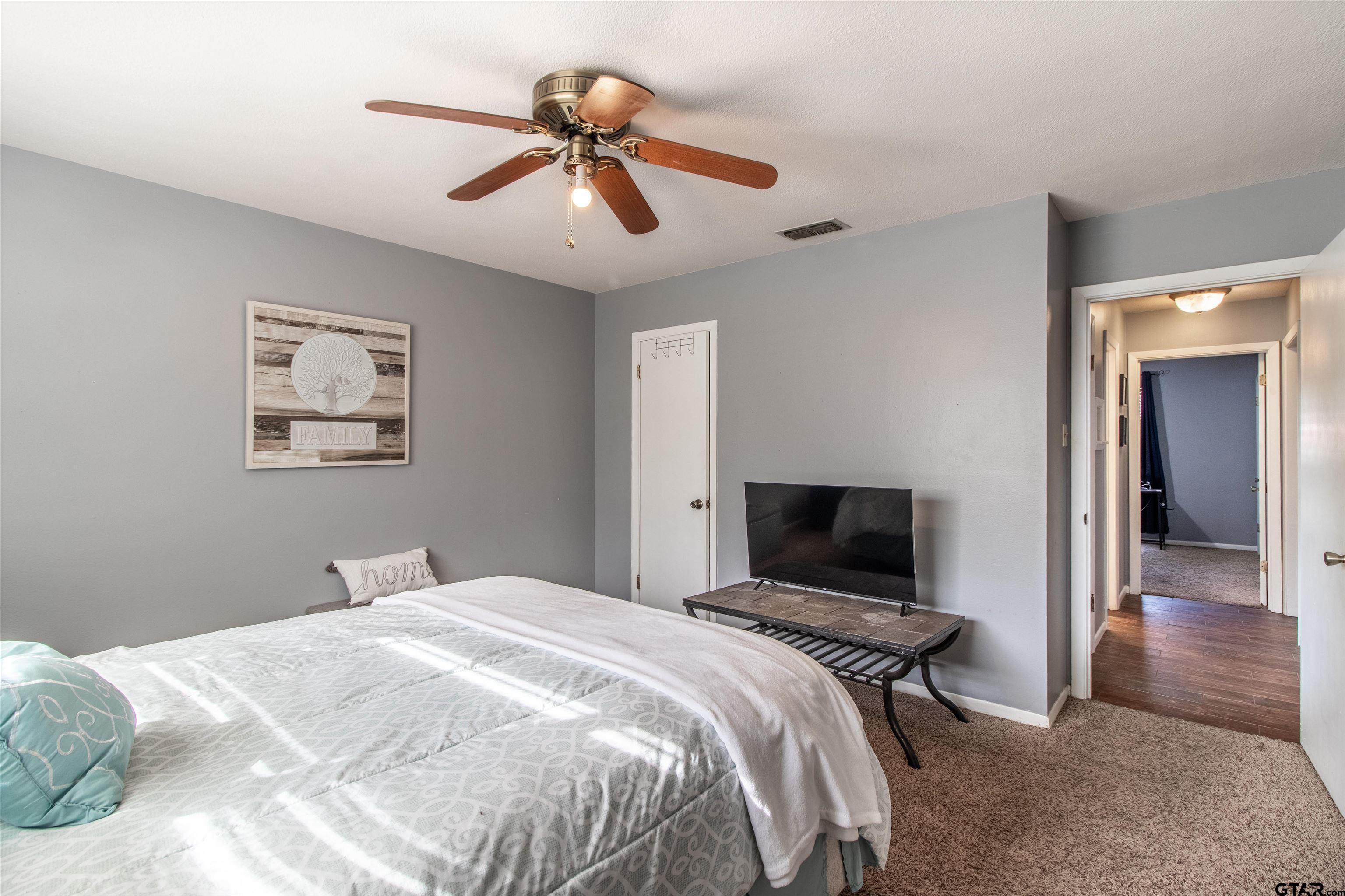 727 Oxford Drive Tyler, TX 75703 - Photo 22 of 33 a bedroom with a bed and a flat screen tv