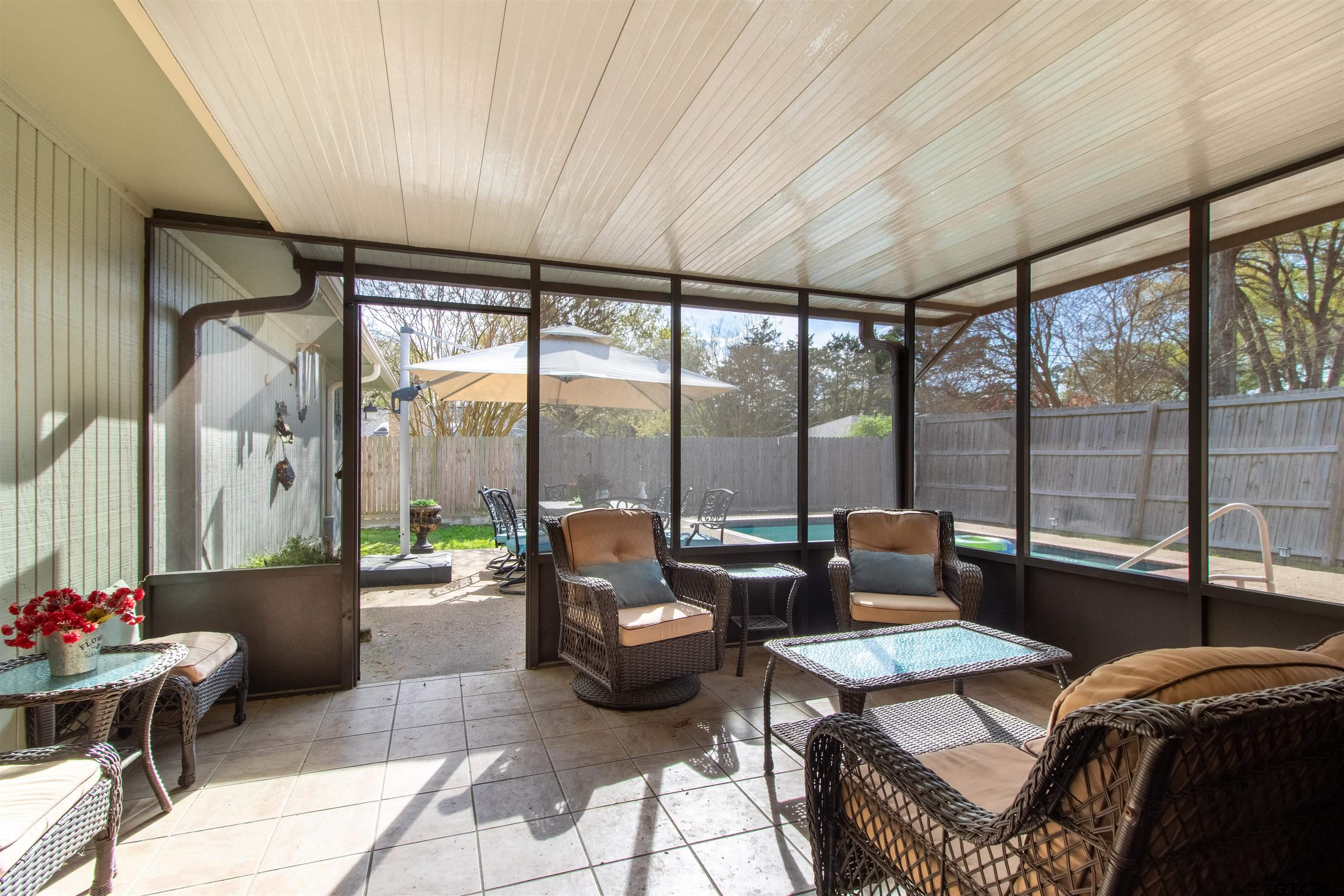 727 Oxford Drive Tyler, TX 75703 - Photo 23 of 33 a living room with furniture and a floor to ceiling window