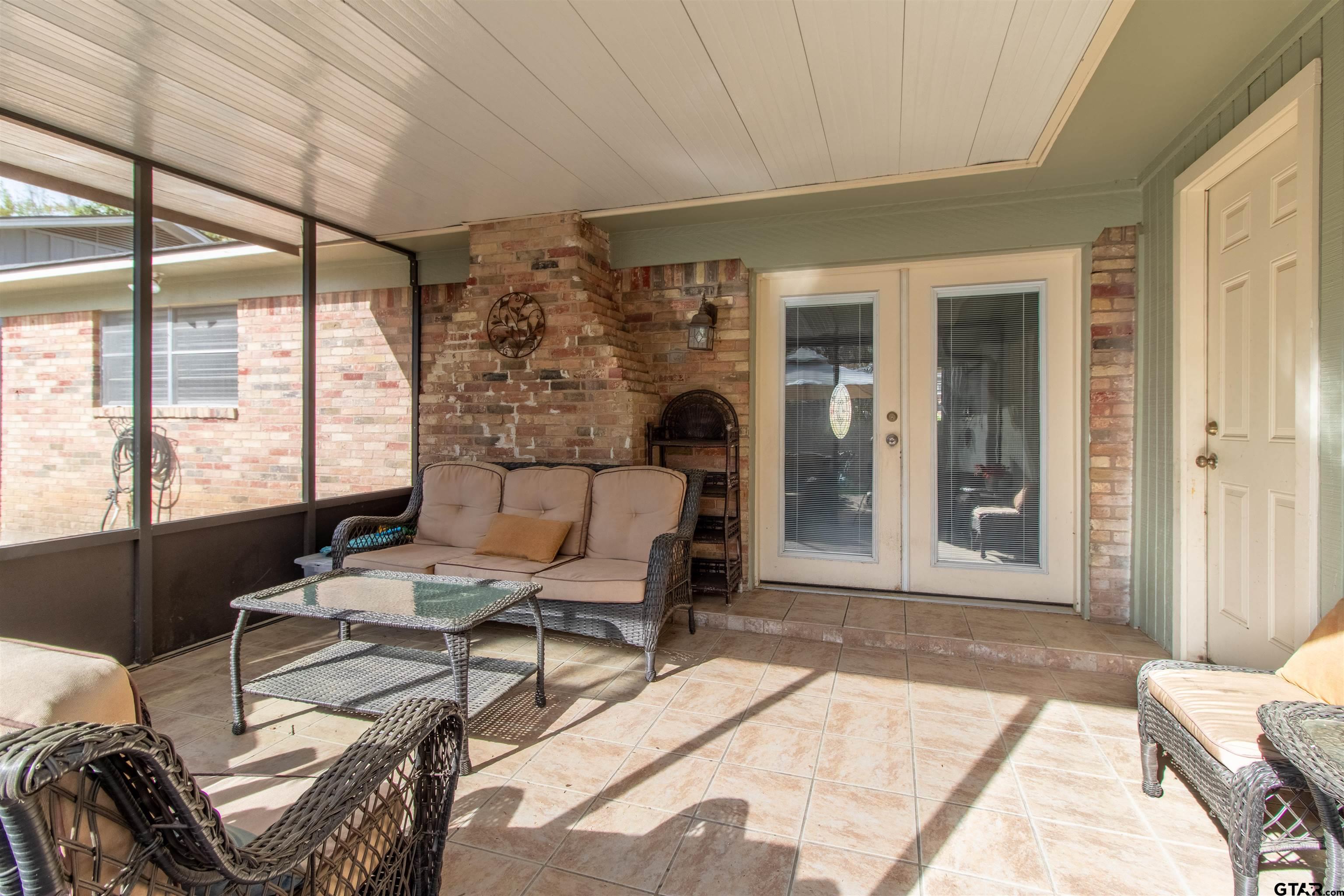 727 Oxford Drive Tyler, TX 75703 - Photo 24 of 33 a living room with furniture and floor to ceiling windows