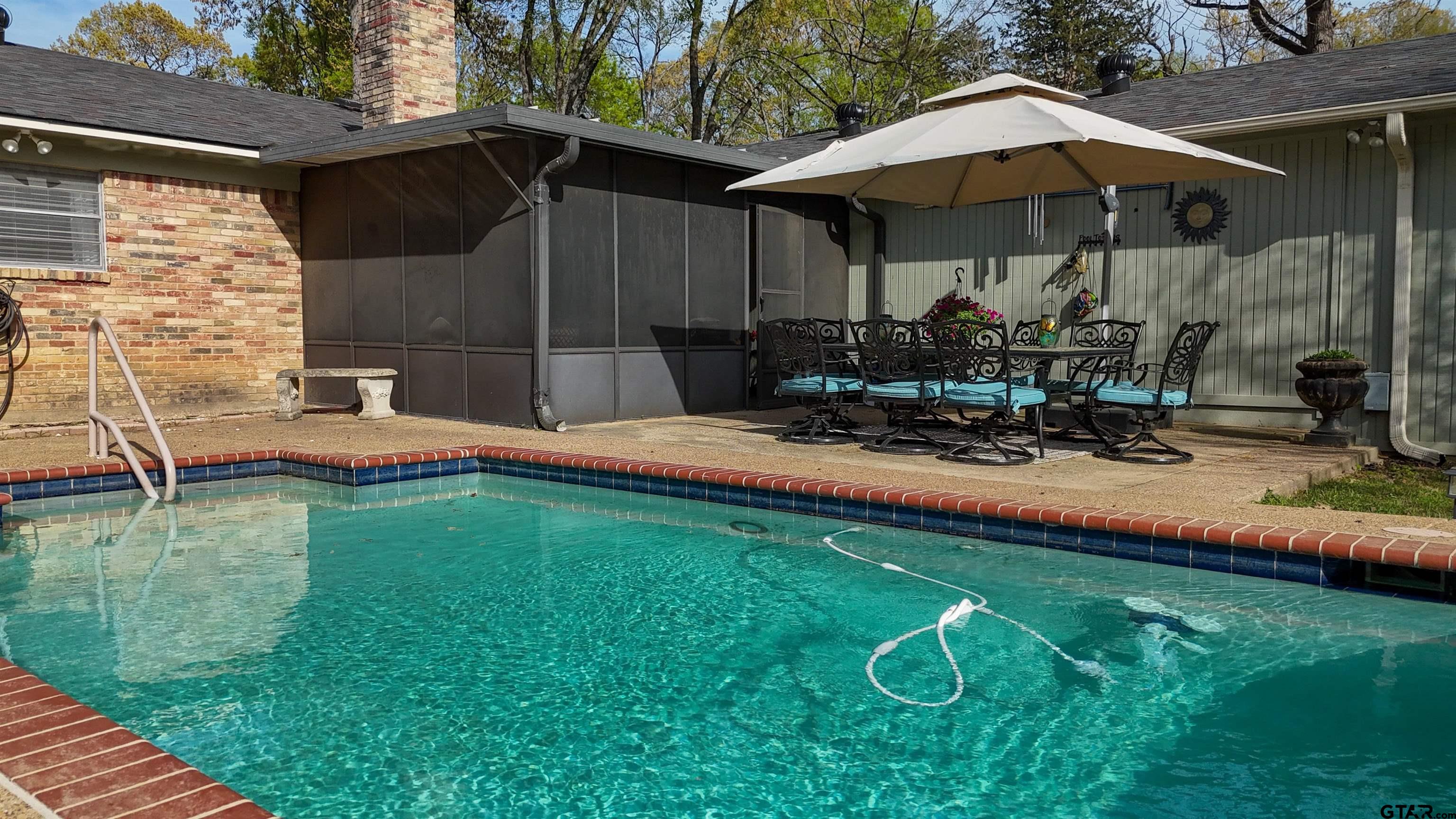 727 Oxford Drive Tyler, TX 75703 - Photo 27 of 33 a view of a wooden deck with chairs and an umbrella