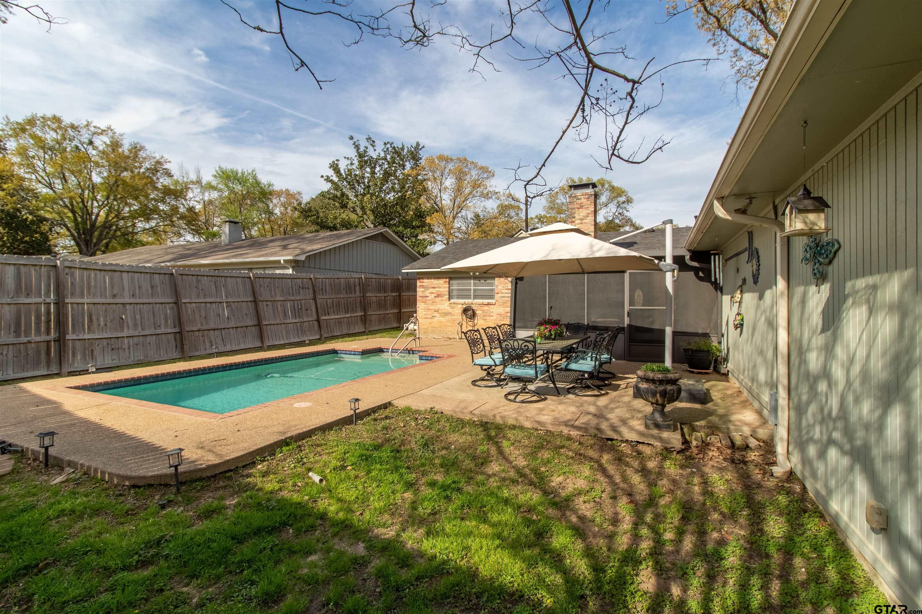 727 Oxford Drive Tyler, TX 75703 - Photo 30 of 33 a view of a backyard with sitting area