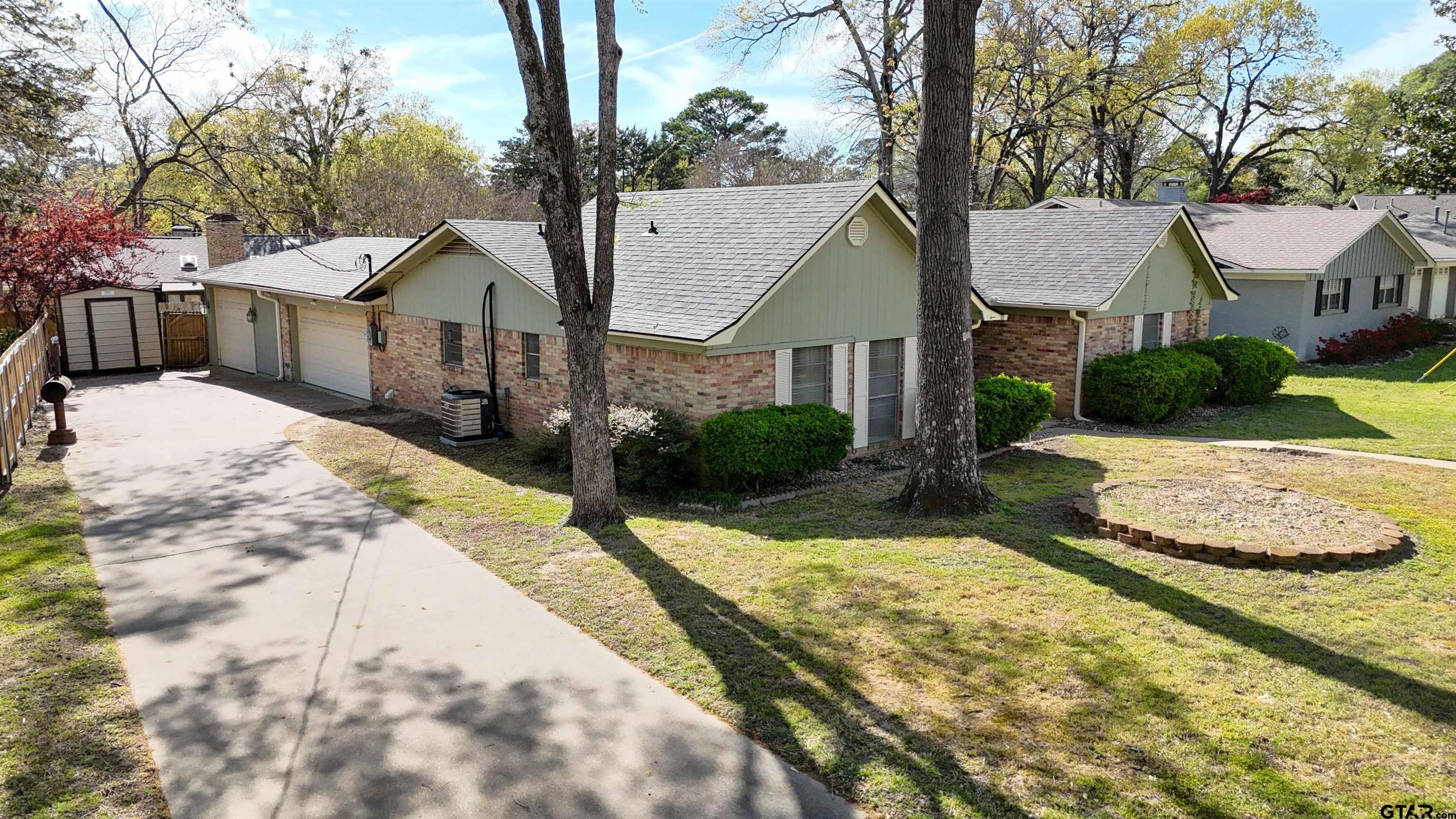 727 Oxford Drive Tyler, TX 75703 - Photo 3 of 33 a front view of a house with a yard and garage