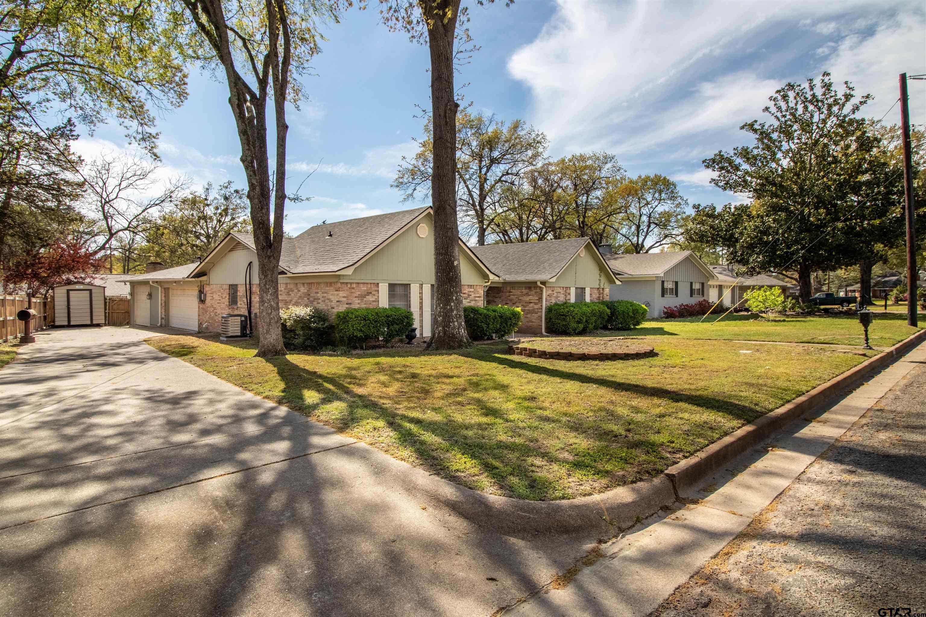 727 Oxford Drive Tyler, TX 75703 - Photo 32 of 33 a view of yard with swimming pool and trees
