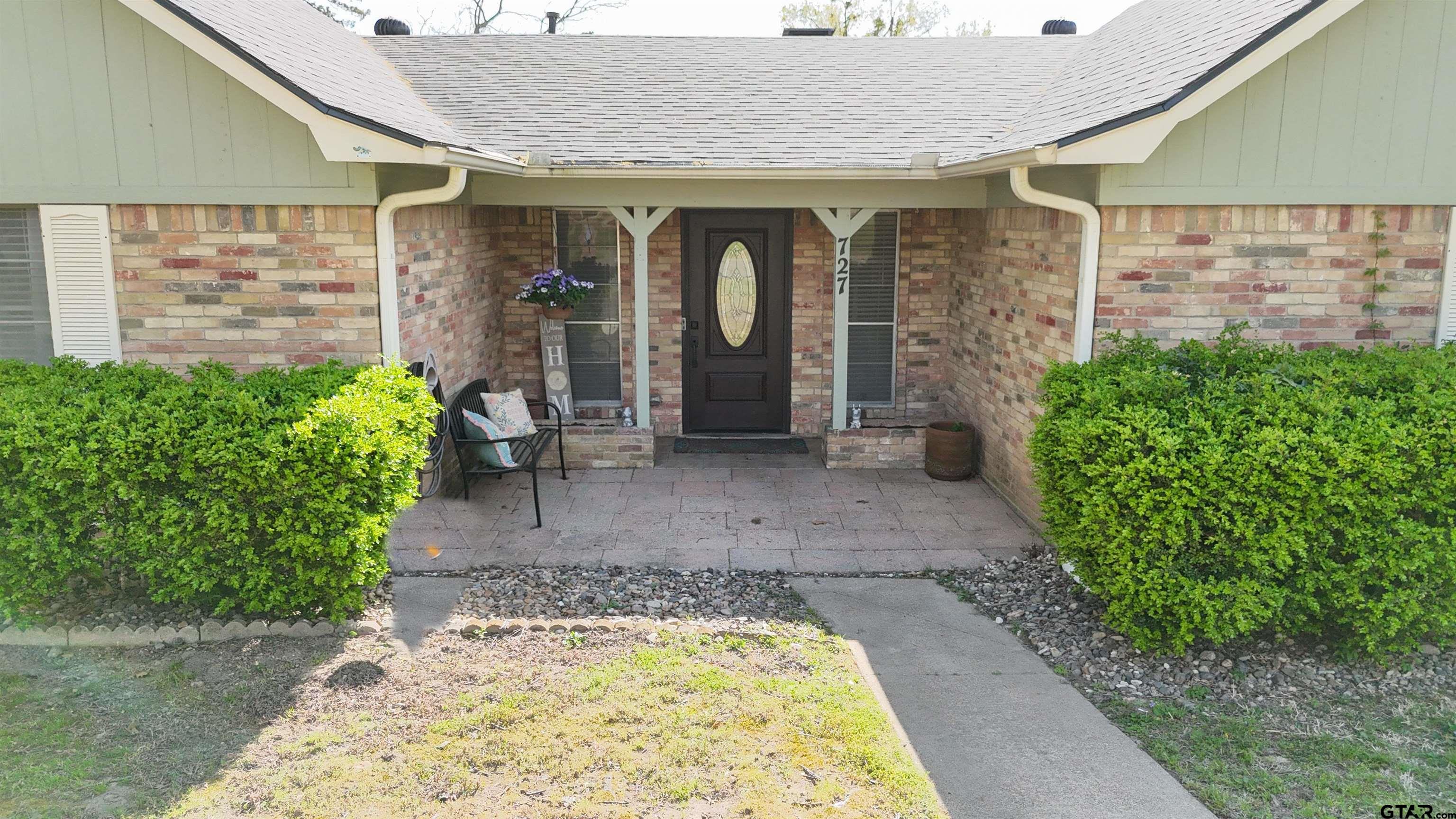727 Oxford Drive Tyler, TX 75703 - Photo 4 of 33 a front view of a house with garden