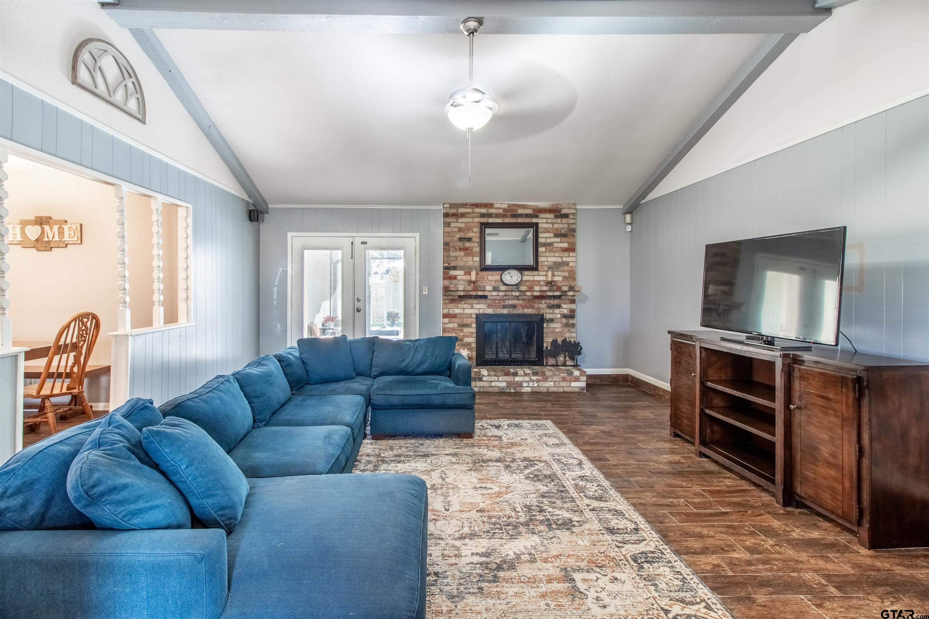 727 Oxford Drive Tyler, TX 75703 - Photo 6 of 33 a living room with furniture a flat screen tv and kitchen view