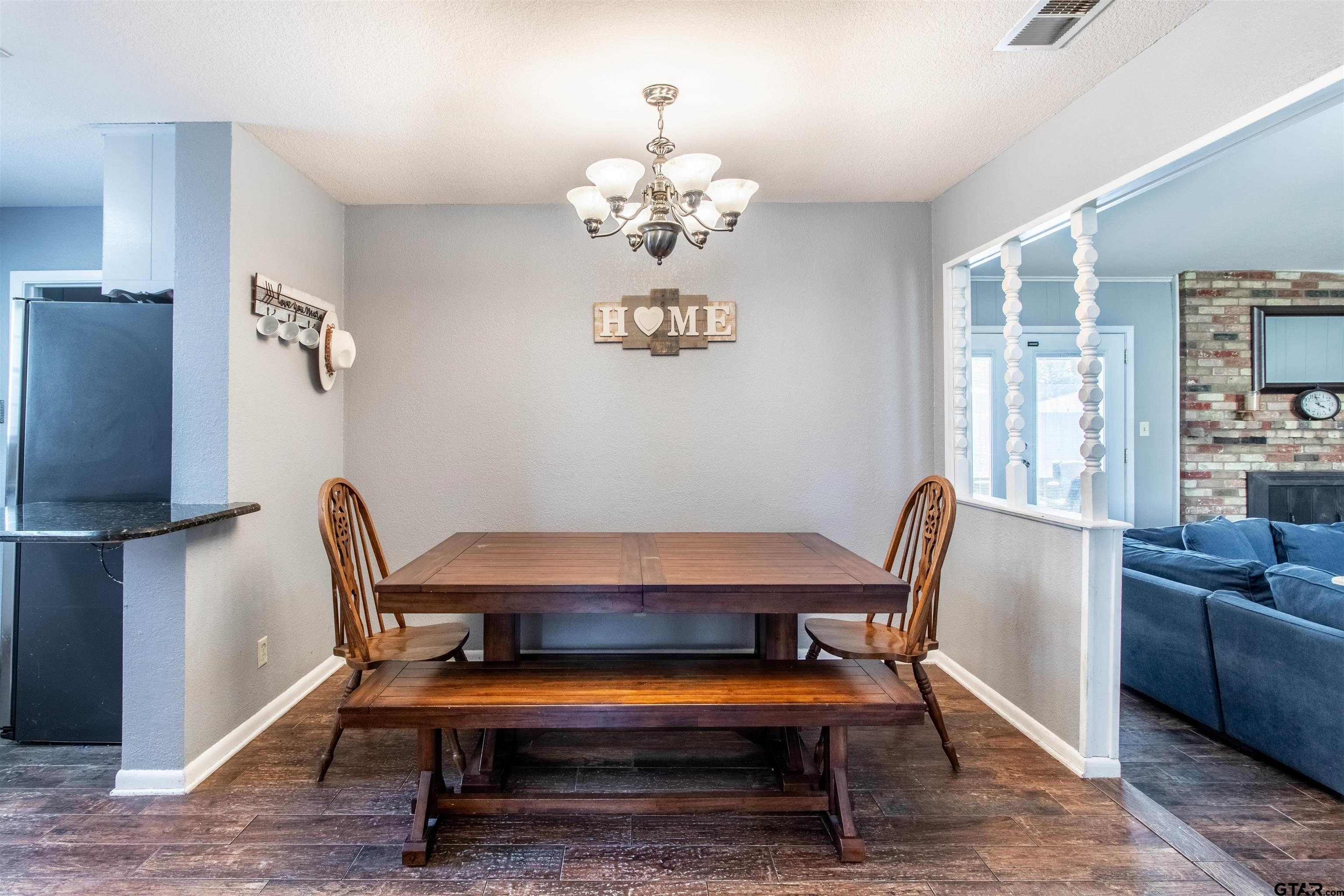 727 Oxford Drive Tyler, TX 75703 - Photo 9 of 33 a view of a dining room with furniture window and wooden floor