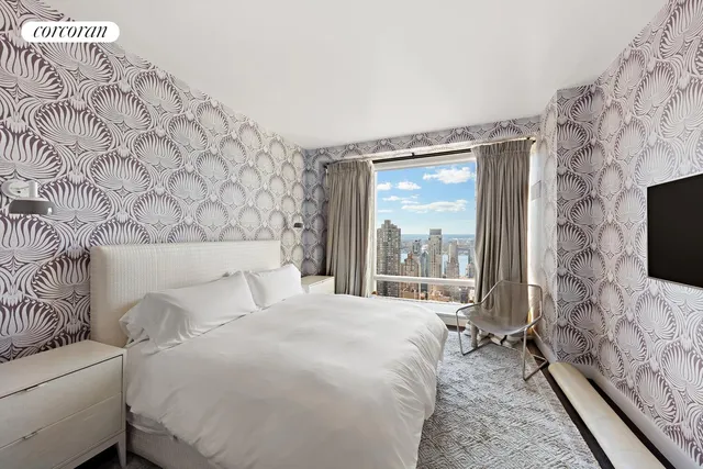 a bedroom with a large bed and a large window